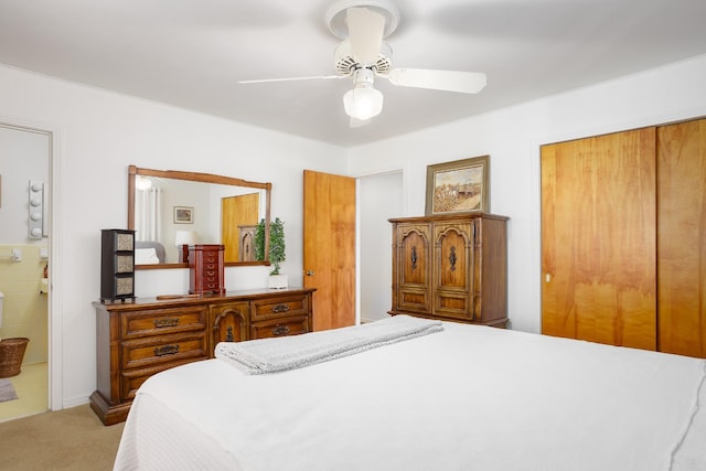 bedroom with a ceiling fan, a closet, carpet flooring, and ensuite bath