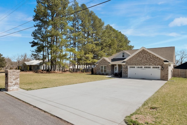 view of front of house featuring a garage, brick siding, fence, driveway, and a front lawn