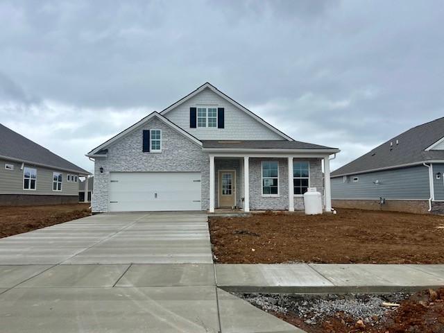 view of front of home with concrete driveway and an attached garage