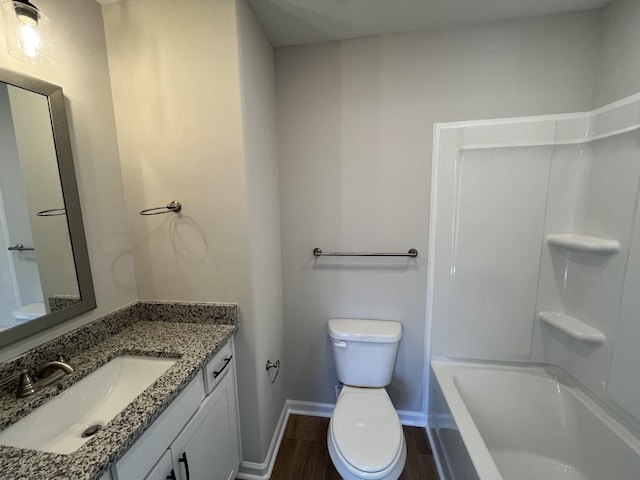 bathroom featuring vanity, wood finished floors, toilet, and baseboards