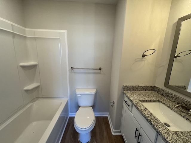 bathroom with toilet, baseboards, wood finished floors, and vanity