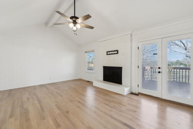 unfurnished living room featuring french doors, visible vents, lofted ceiling with beams, a brick fireplace, and light wood-type flooring