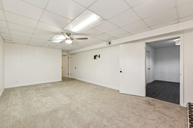 interior space with ceiling fan, a drop ceiling, carpet flooring, and visible vents