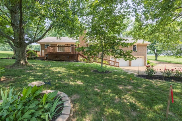 view of yard with driveway, a wooden deck, an attached garage, and stairs