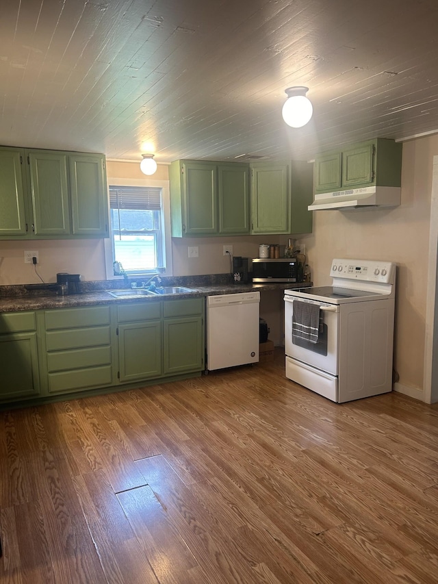 kitchen featuring green cabinets, white appliances, a sink, and under cabinet range hood