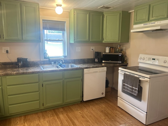 kitchen featuring green cabinetry, white appliances, a sink, and under cabinet range hood