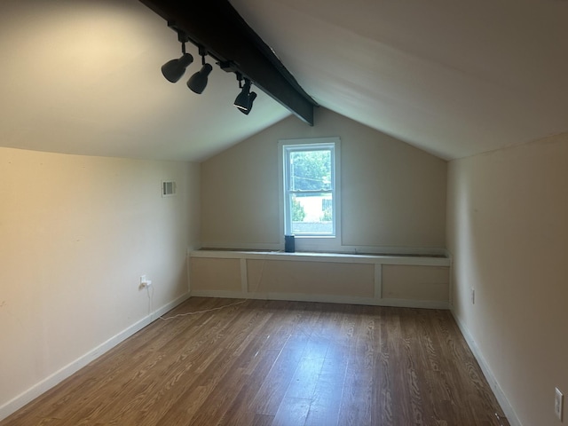 bonus room featuring vaulted ceiling, wood finished floors, visible vents, and baseboards