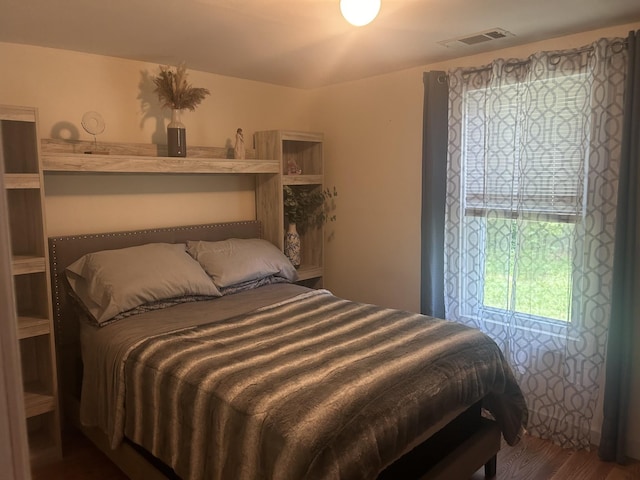 bedroom with visible vents and wood finished floors