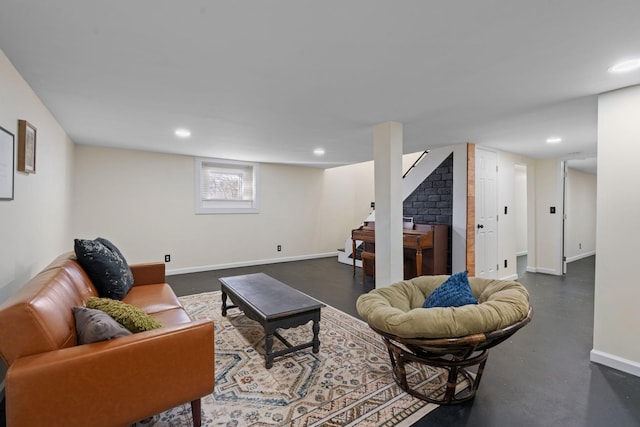 living area with finished concrete floors, baseboards, and recessed lighting