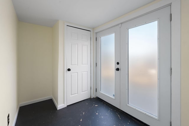 entryway featuring french doors, concrete floors, and baseboards