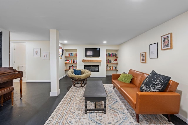 living room featuring built in features, a glass covered fireplace, baseboards, and recessed lighting