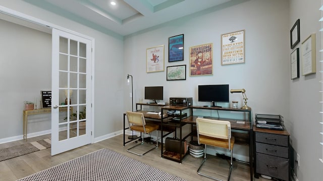 office space with baseboards, wood finished floors, and french doors