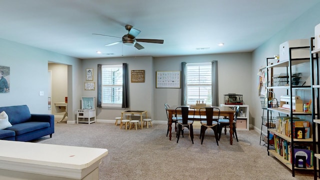 game room featuring a healthy amount of sunlight, ceiling fan, baseboards, and light colored carpet