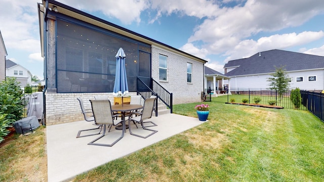 back of house with entry steps, a fenced backyard, a lawn, and a patio