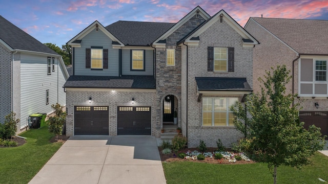 view of front of house with a front lawn, concrete driveway, and brick siding