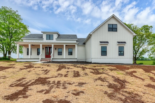 modern inspired farmhouse featuring board and batten siding, covered porch, roof with shingles, and a ceiling fan