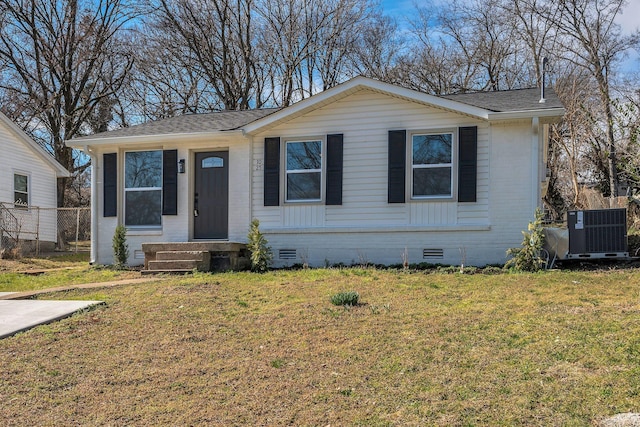 view of front of house featuring crawl space, central air condition unit, a shingled roof, and a front yard