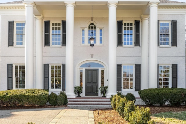 property entrance featuring brick siding