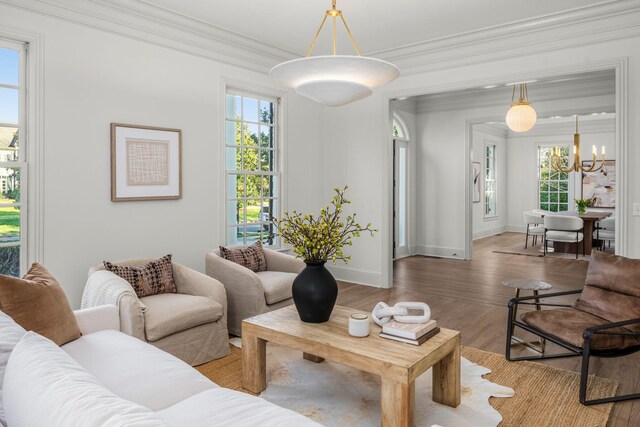 5042 Hill Place Dr, Nashville, TN 37205 - living room with ornamental molding, an inviting chandelier, wood finished floors, and baseboards