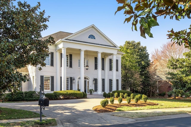 greek revival house featuring driveway