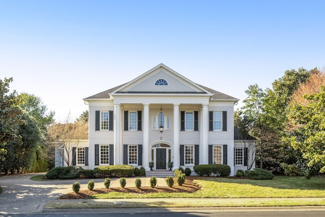 greek revival house with a front lawn