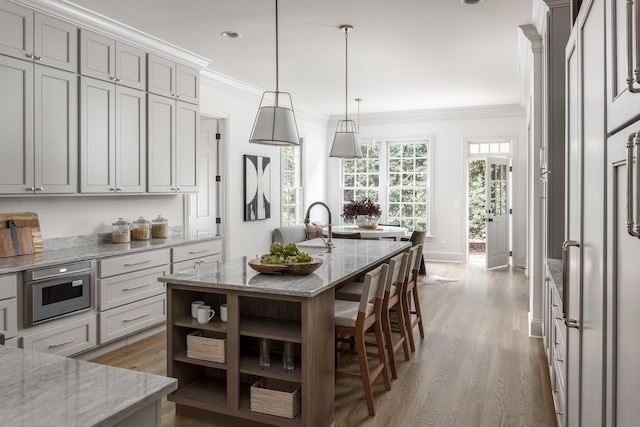 5042 Hill Place Dr, Nashville, TN 37205 - kitchen with light stone counters, crown molding, and wood finished floors