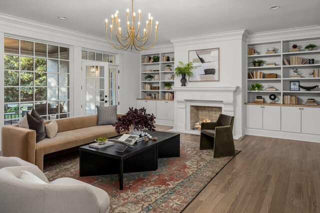 5042 Hill Place Dr, Nashville, TN 37205 - living room with built in features, a fireplace with flush hearth, ornamental molding, wood finished floors, and french doors