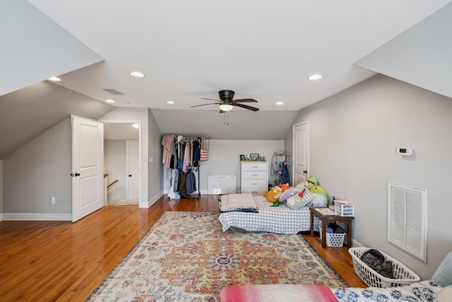 bedroom featuring lofted ceiling, wood finished floors, and visible vents