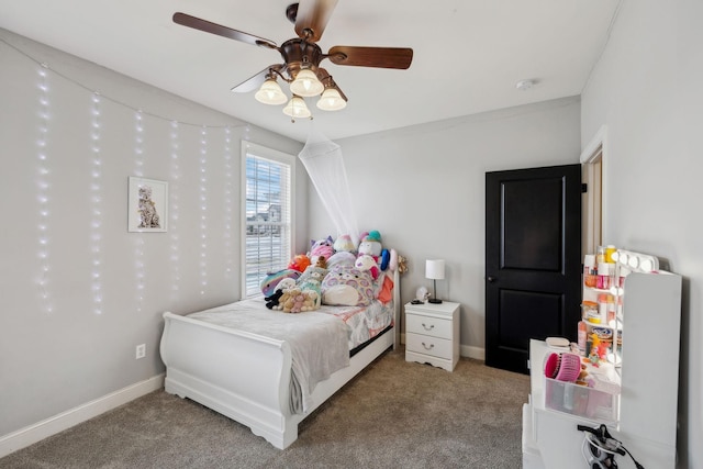 carpeted bedroom featuring a ceiling fan and baseboards