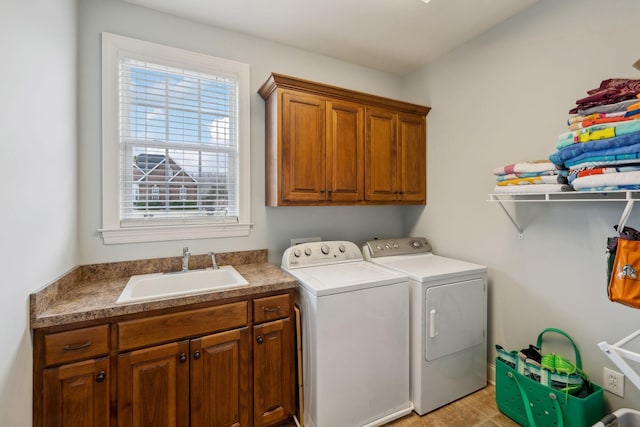 washroom with separate washer and dryer, a sink, and cabinet space