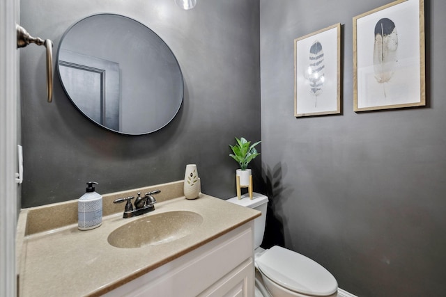 half bathroom with toilet and vanity