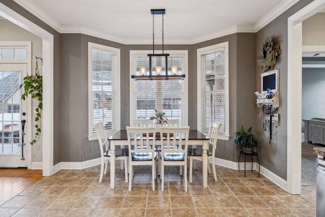 dining room with light tile patterned floors, baseboards, a chandelier, and ornamental molding