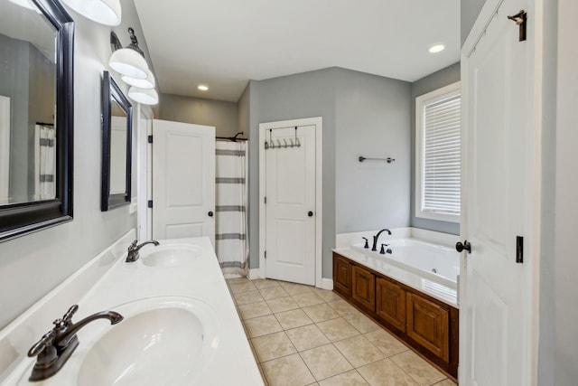 bathroom with tile patterned flooring, a garden tub, a sink, and double vanity