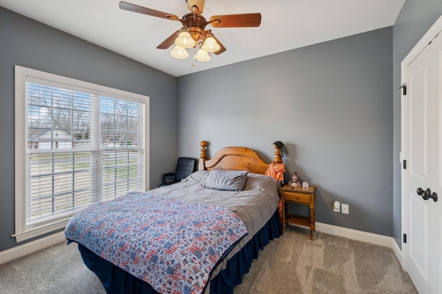 bedroom featuring ceiling fan, carpet, and baseboards