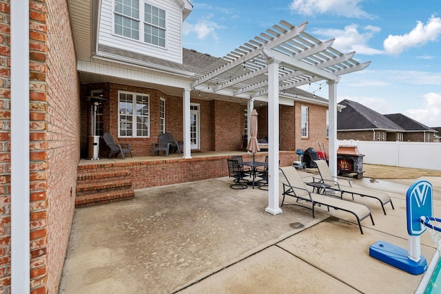 view of patio with outdoor dining area, fence, and a pergola