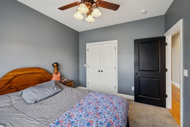 carpeted bedroom featuring a closet, a ceiling fan, and baseboards