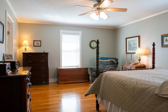 bedroom with ceiling fan, wood finished floors, and crown molding