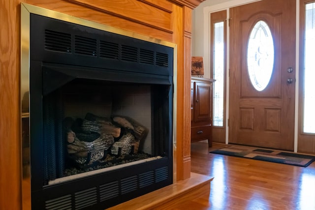 foyer entrance featuring wood finished floors and a wealth of natural light