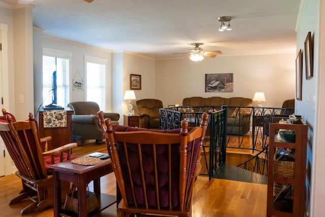 dining area with ornamental molding, a ceiling fan, and wood finished floors