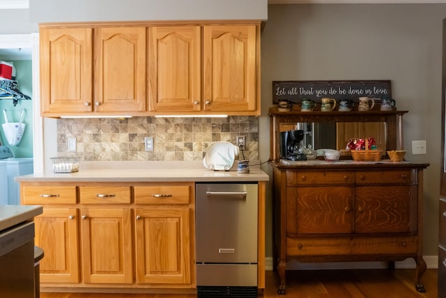 kitchen with dishwasher, light countertops, washer / clothes dryer, and decorative backsplash