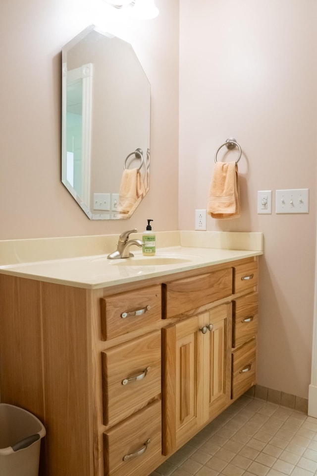 bathroom featuring vanity, baseboards, and tile patterned floors