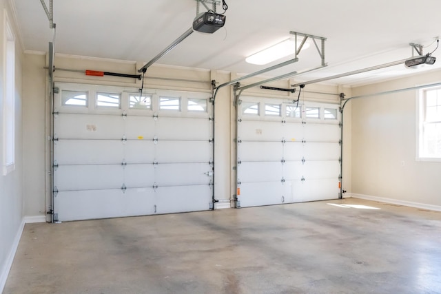 garage with baseboards and a garage door opener