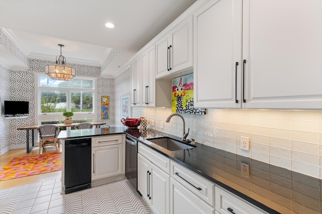 kitchen featuring ornamental molding, white cabinetry, a sink, and wallpapered walls