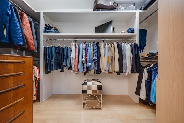 walk in closet featuring wood finished floors