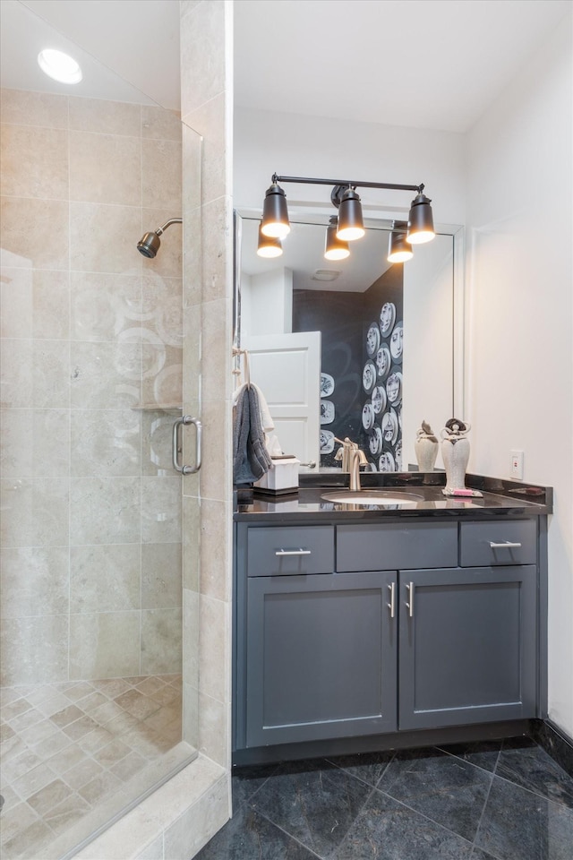 bathroom with a shower stall and vanity