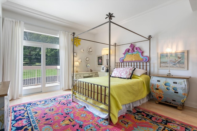 bedroom with access to outside, crown molding, and wood finished floors