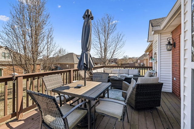 wooden terrace with outdoor dining space and an outdoor living space