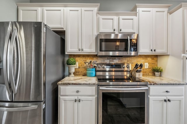 kitchen with white cabinetry, stainless steel appliances, and decorative backsplash