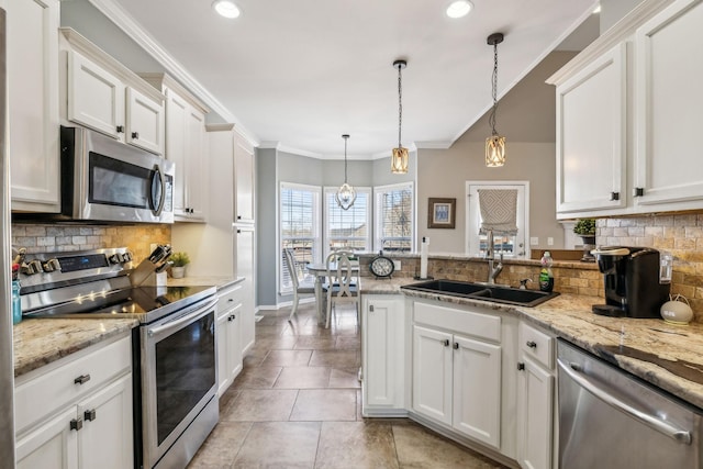 kitchen with stainless steel appliances, a peninsula, white cabinetry, backsplash, and crown molding