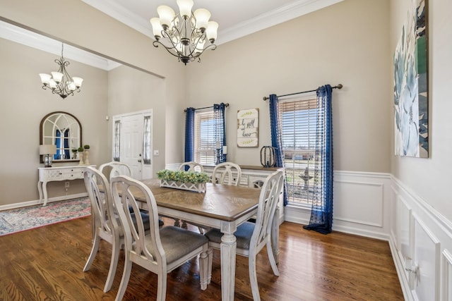 dining space featuring ornamental molding, dark wood finished floors, and a notable chandelier